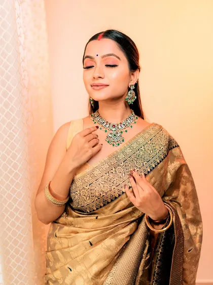 A serene, eyes-closed shot highlighting the soft, peachy eyeshadow.