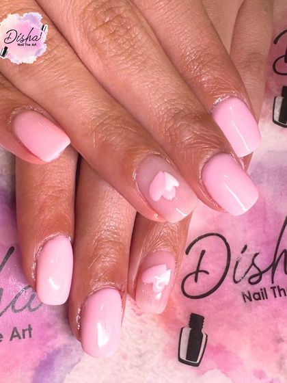 A sweet and simple design with a soft pink base and a delicate heart on the accent nail.