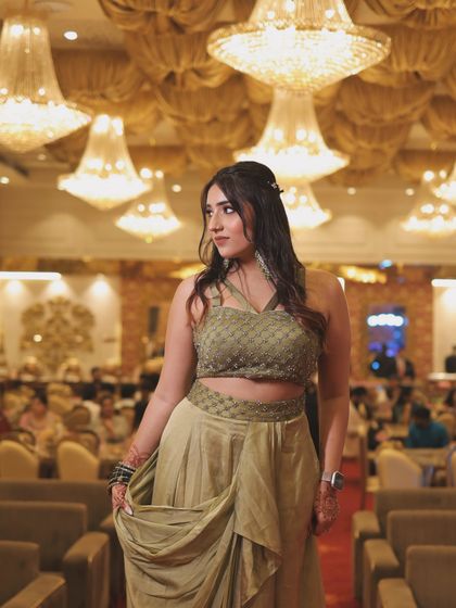 A full-length shot of the olive green outfit. This showcases the unique cut and drape of the modern ethnic wear.