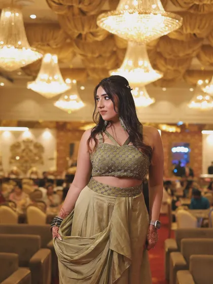 A full-length shot of the olive green outfit. This showcases the unique cut and drape of the modern ethnic wear.