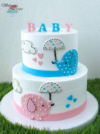 A studio shot of the two-tier elephant baby shower cake, showing the clean lines and cute fondant details.