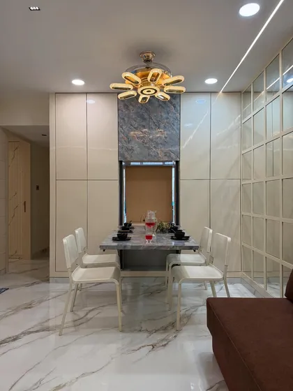 A frontal view of the space-saving dining unit, shown here in its compact form. The design includes integrated storage and is crowned by a modern fan-style chandelier.