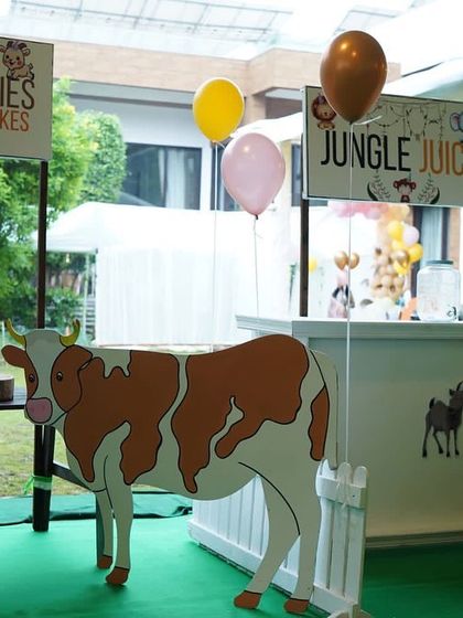 For the Boho Chic animal party, I set up themed food and drink stations, like this 'Milk & Cookies' stand with a life-sized cow prop.