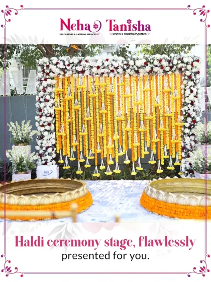 We present your Haldi ceremony stage with flawless elegance. This setup features a beautiful curtain of fresh marigolds framed by pure white florals, with traditional brass 'urli' bowls ready for the ceremony.