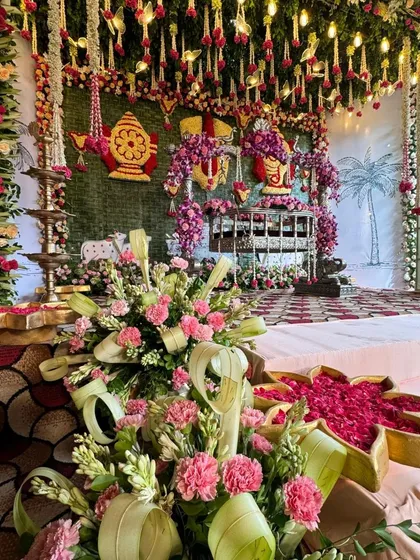 A close-up of the floral arrangements and offerings at the grand naming ceremony.