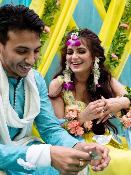 A candid moment of laughter and love as the couple interacts during their haldi ceremony.