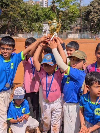 The culmination of hard work. A young team hoists their championship trophy, a powerful image of teamwork and success.