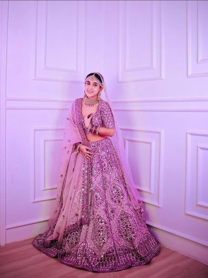 A full-length view of the stunning lilac lehenga, showing its grand skirt and coordinated dupatta. Renting allows you to wear such a magnificent couture piece for your event.