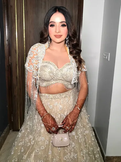 A full view of the glittery lehenga and the complementary glam makeup, perfect for a bride-to-be.