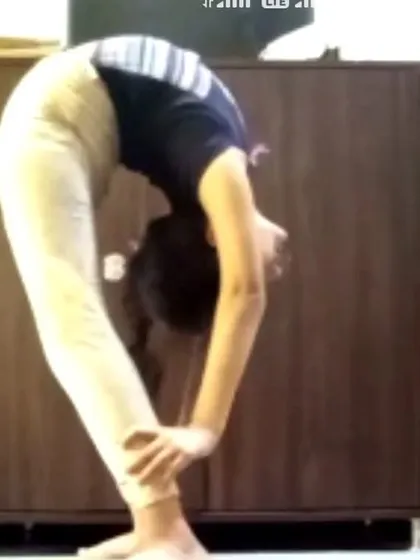 An online student performs a standing backbend, demonstrating excellent flexibility. This shows that progress is possible whether you practice with me in the studio or online.