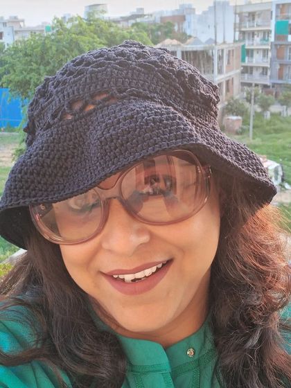 A happy selfie in my favorite crochet bucket hat. It's lightweight, breathable, and easy to pack, making it a great travel companion.