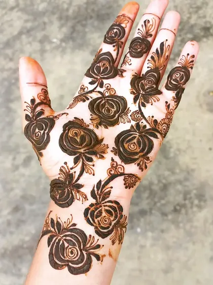 A simple yet elegant design featuring a scattering of roses across the hand. This is a great option for someone who wants a lighter, more minimalist look.