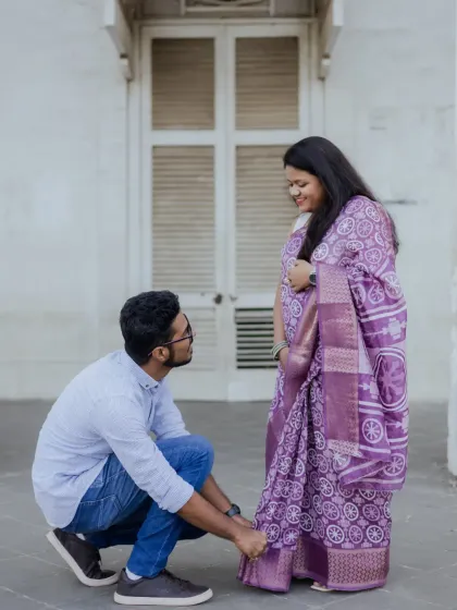 A caring and playful moment where the groom-to-be helps his partner with her footwear. It's these small, genuine gestures that I love to capture.