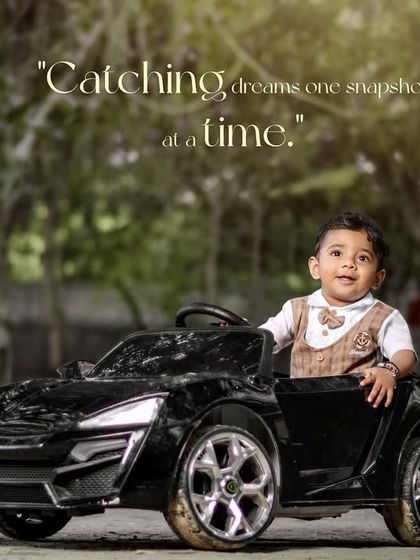 Catching dreams one snapshot at a time. A happy boy in a stylish vest enjoys a ride in his toy car.