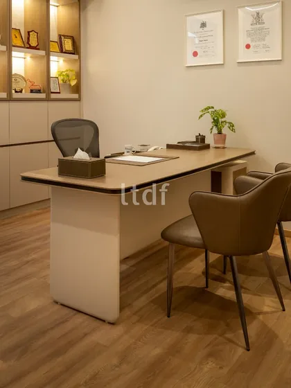 The doctor's consultation room is designed to be professional yet approachable. The clean lines of the furniture, warm wood flooring, and ample storage create a functional and organized space that instills confidence and comfort.