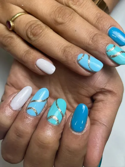 How about some blue hues with a sparkly twist? This design features different shades of blue, with gold glittery lines adding a touch of glamour.