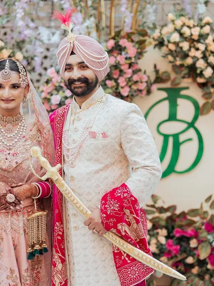 A real wedding moment from a beautiful Amritsar celebration. The custom 'JB' monogram I designed is featured prominently in the decor, creating a sophisticated and personal backdrop for the couple's cherished photos.