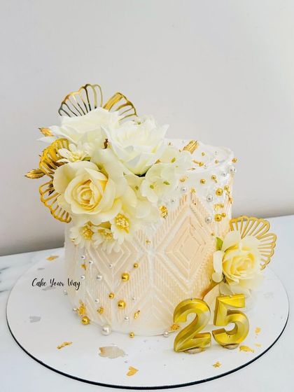 Because every milestone deserves to be celebrated in style. An elegant white and gold cake for a 25th anniversary.