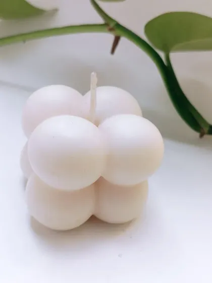 My soy wax bubble candle is a piece of decor in itself. This clean, minimalist shot shows its unique shape that brings a modern and playful touch to any space, even before it's lit.