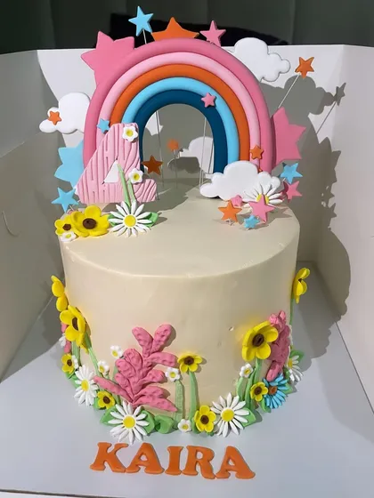 Brighten up any birthday with this cheerful rainbow and flowers cake. The colourful fondant rainbow and variety of flowers make this a vibrant and happy design, perfect for a 4th birthday party.