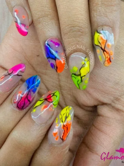 Unleash your inner artist with this vibrant explosion of color. We used a negative space technique, allowing bright neon pigments in orange, blue, pink, and lime green to pop in an abstract, tree-like pattern. It's wearable art for your fingertips.