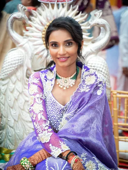 A seated portrait that captures the serene and devotional mood of the Siddhi Tap ceremony. The makeup is understated and beautiful.