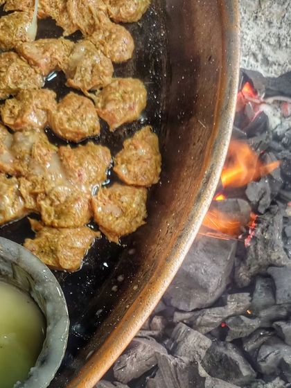 Watching the famous Tunday Kebabs being cooked over charcoal. They are so soft they literally melt in your mouth.