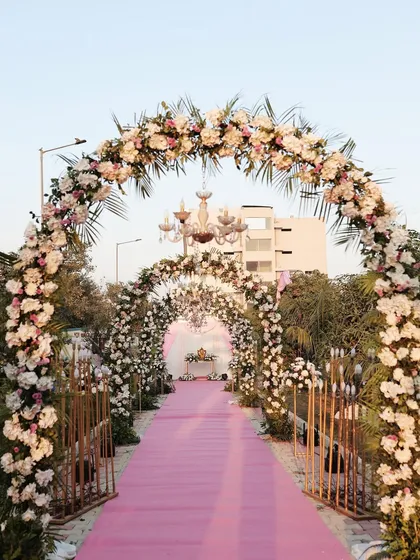 A perfect entrance for a fairytale day wedding. This grand floral archway, layered with pink and white flowers, creates an unforgettable welcome and a stunning photo opportunity.
