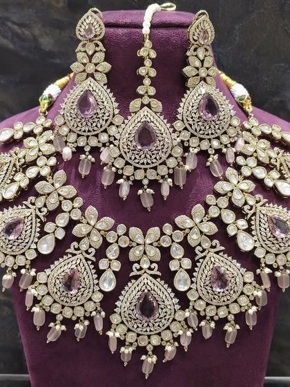 A grand, floral-inspired choker set with pastel purple stones and intricate silver-toned metalwork. This is a true statement piece for any occasion.