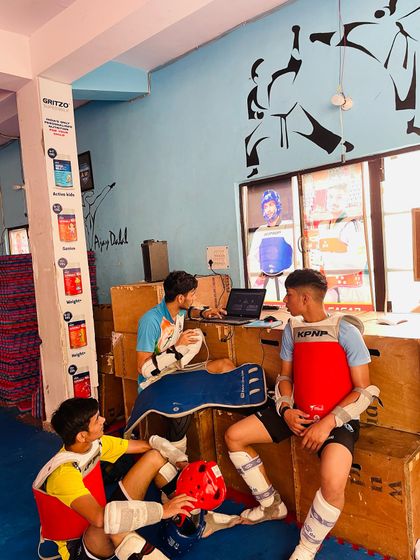 Training time is also strategy time. Athletes analyzing fight footage together to learn and improve.