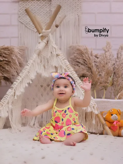 A happy wave from our little adventurer in the teepee. Studio sessions are great for capturing these cute, interactive moments.
