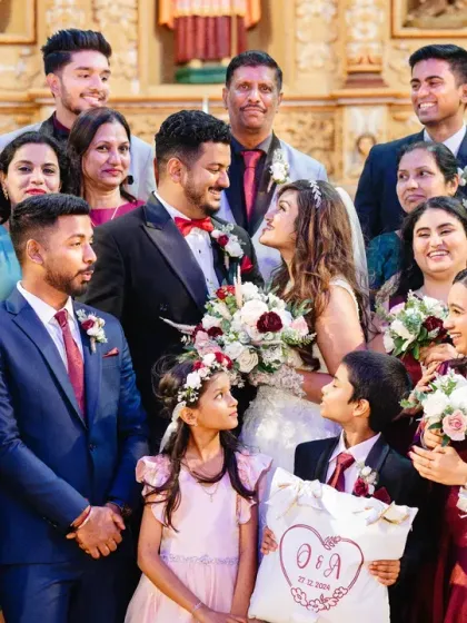 A beautiful group photo of the couple with their family and bridal party after the ceremony.