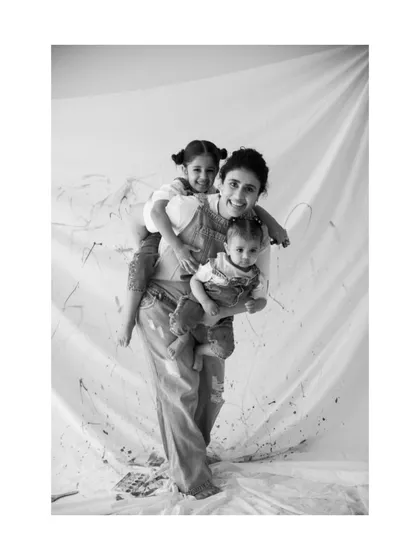 The beautiful chaos of motherhood, captured during a playful 'Paint Me' session. I love freezing these moments of pure joy, where laughter is the only thing that matters.