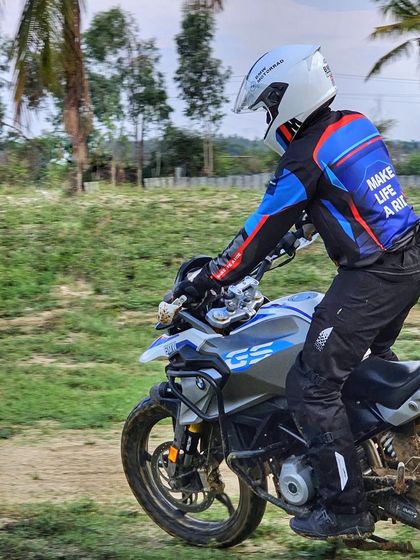 A close-up action shot of a rider on his BMW GS during a drill. Notice the focused posture and dirt-caked tires, signs of a productive day learning adventure bike skills.