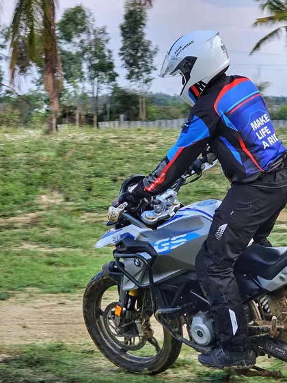 A close-up action shot of a rider on his BMW GS during a drill. Notice the focused posture and dirt-caked tires, signs of a productive day learning adventure bike skills.