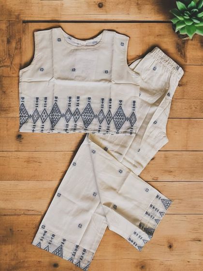 I love the simple elegance of this Jamdani cotton set. The traditional woven motifs on the crop top and pants create a beautiful, understated look that is still soft and comfortable enough for a child to wear.