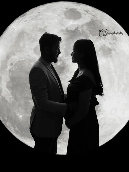 A creative silhouette of a couple against a full moon backdrop, perfect for a dramatic and artistic maternity photo.