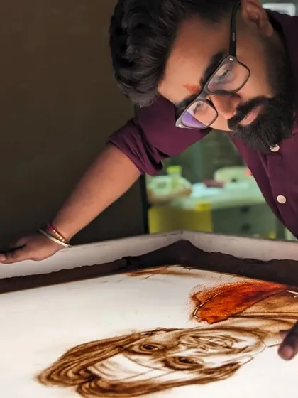 Focusing on the details of Neeraj Chopra's face in my sand art tribute.