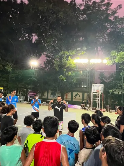 Young players listening intently during an inspirational talk. We believe in connecting our athletes with positive role models in sports.