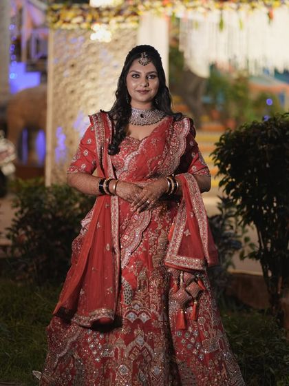 A complete view of Amrutha's stunning reception lehenga and makeup. The entire look is coordinated to create a feeling of royal elegance.