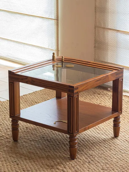Different views of the Kulam collection, including the side table and center table. These images showcase the blend of solid teak, glass, and narrative brass accents that define this collection.