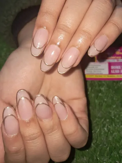 A minimalist and chic design featuring a nude base with a simple, elegant gold chrome line accenting the nail.