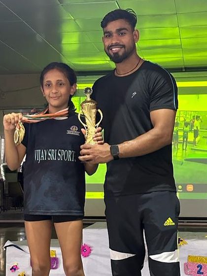 One of our gymnasts with her Best Gymnast award trophy and medal. We celebrate individual excellence as well as team success.