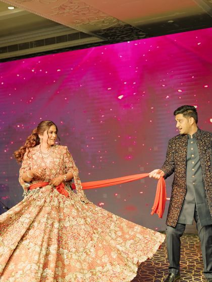 A playful moment from a couple's performance, inspired by classic Bollywood romance. Using a simple prop like a dupatta can add so much drama and fun to the choreography.