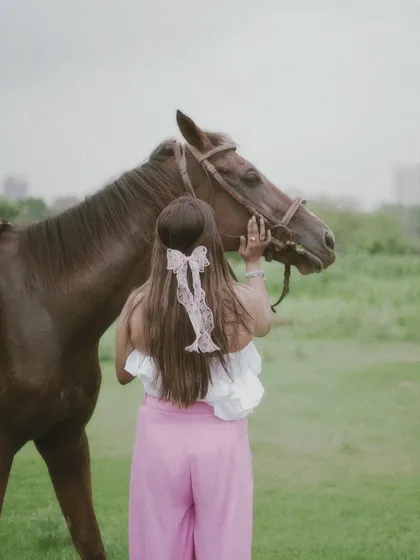 Another perspective of a rider and her horse, emphasizing the calm and gentle nature of their interaction.