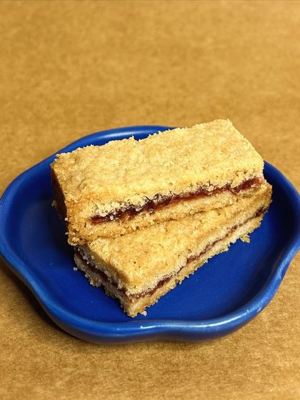 Our signature shortbread just got a jammy twist. Meet our Jim-Jam shortbread bars, featuring a layer of sweet strawberry jam sandwiched between two layers of buttery shortbread.