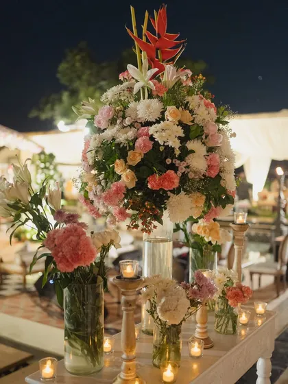 A lush and romantic floral centerpiece combining roses, lilies, and chrysanthemums with warm candlelight. I design tablescapes that are both beautiful and create an intimate atmosphere.