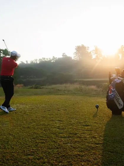 The same sunrise swing, emphasizing the peaceful and focused start to a day of golf. The natural lens flare adds to the beautiful atmosphere of the moment.