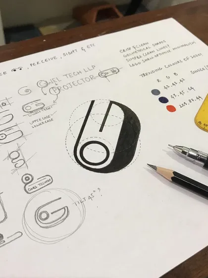 My design process begins with pencil and paper, not pixels. This image shows the initial brainstorming and geometric structuring for the Gwel Tech LLP logo, exploring how the letter 'G' could be visualized as a projector, moving from rough concepts to a refined, calculated form.