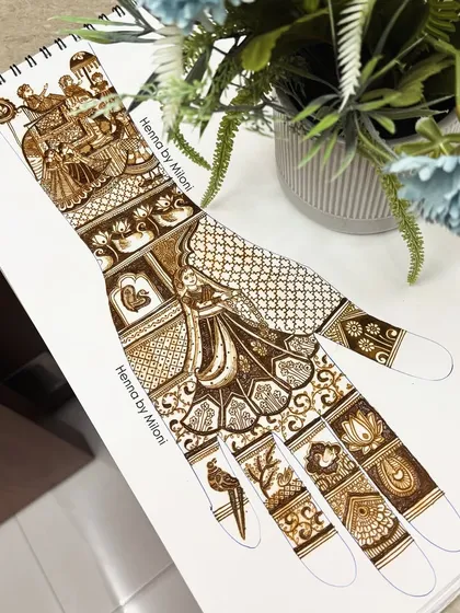 A close-up of a bridal design sketch, showing the intricate details of the bride, doli, and other elements before they are applied to the skin.